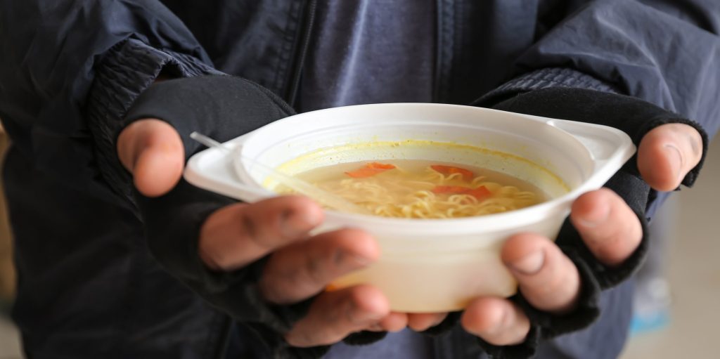 Man holding soup bowl